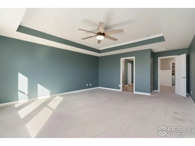 a view of an empty room with a ceiling fan