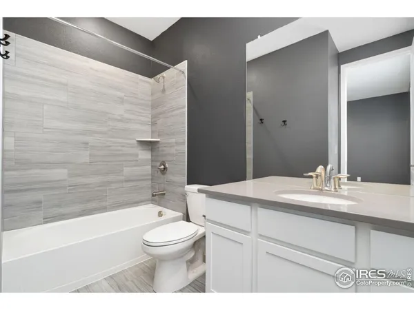 a bathroom with a sink toilet vanity and tub