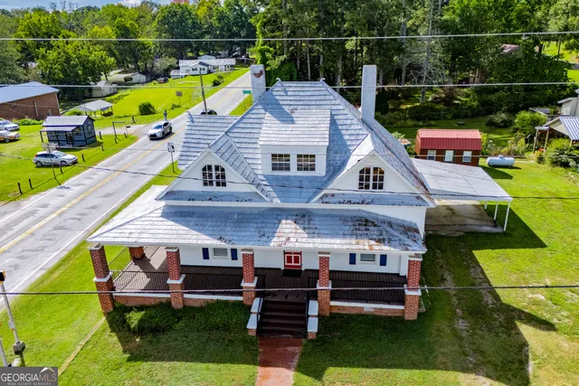 a view of a house with a backyard porch and sitting area