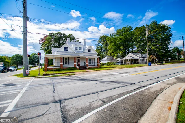 a view of a house with a yard and sitting area