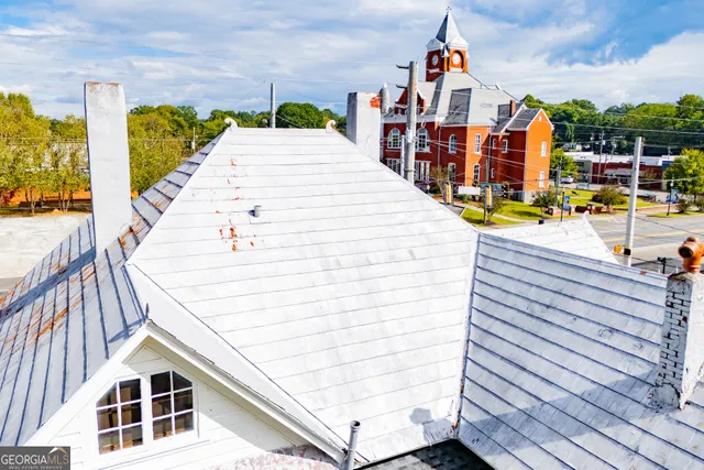 an aerial view of residential house with outdoor space and swimming pool
