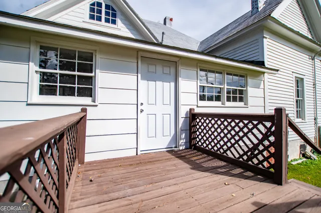 an empty room with windows and fireplace