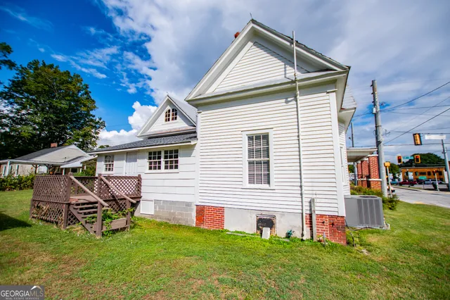 an empty room with a fireplace and painted walls