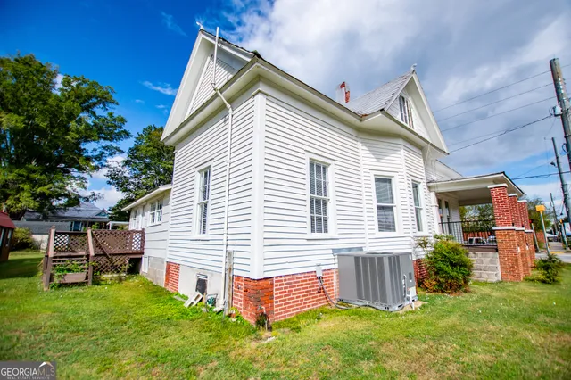 an empty room with fireplace and windows
