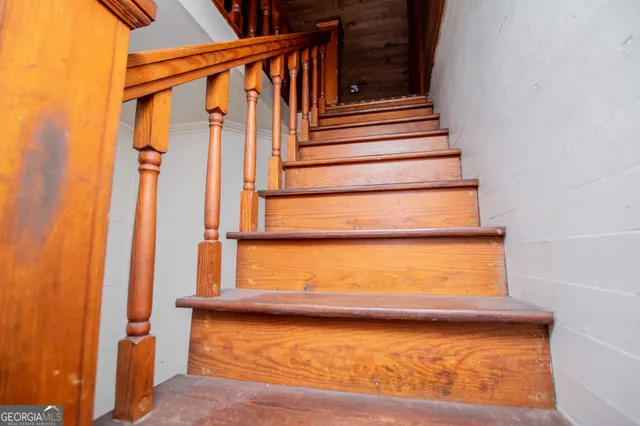 a view of an empty room with a fireplace and a chandelier