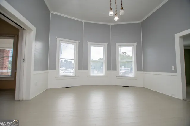 an empty room with windows and closet