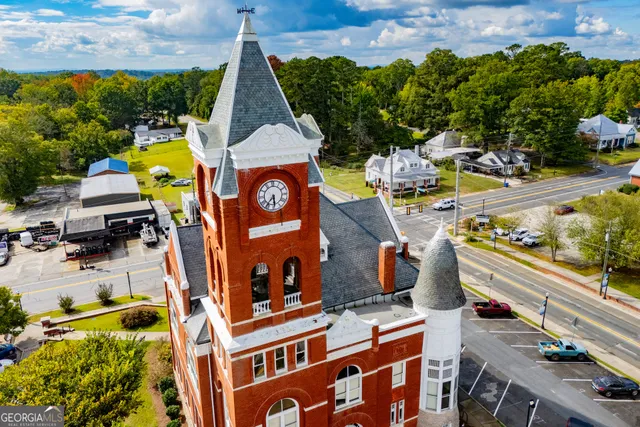 an aerial view of a house with a yard