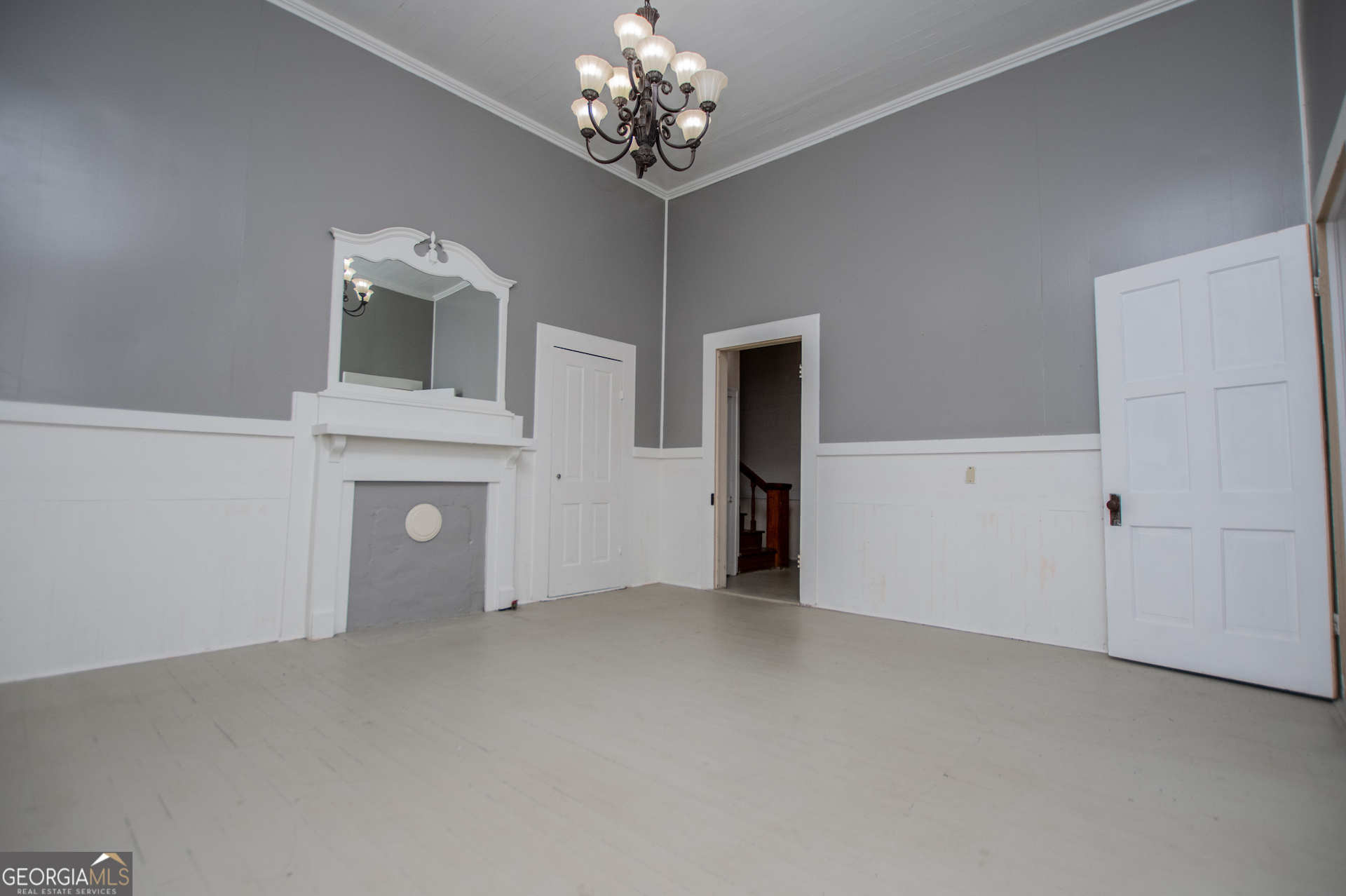 3608 Us Highway Buchanan, GA 30113 - Photo 71 of 92 a view of an empty room with a fireplace and a chandelier