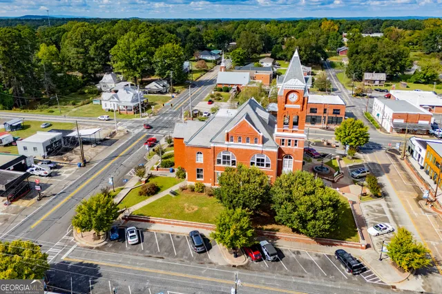 a aerial view of a house with swimming pool and yard
