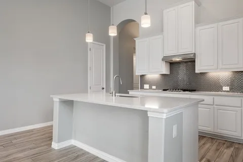 a kitchen with stainless steel appliances a sink and a stove