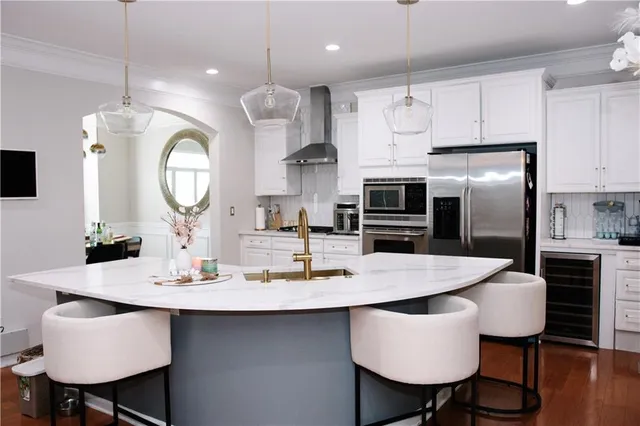 a kitchen with kitchen island a dining table and chairs