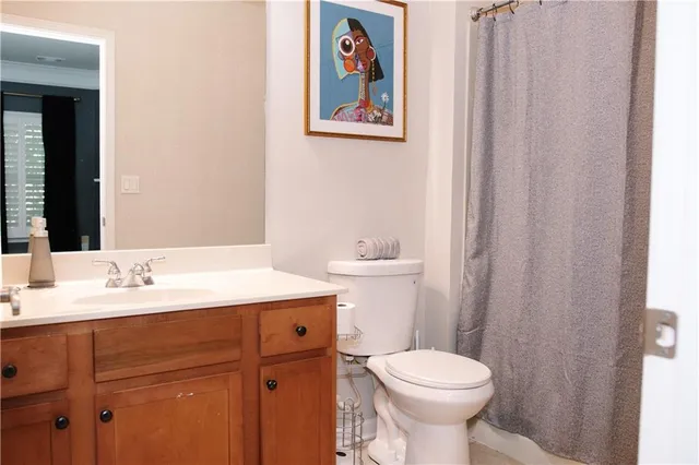 a bathroom with a toilet sink and mirror