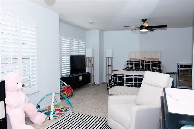 a bedroom with furniture and a flat screen tv