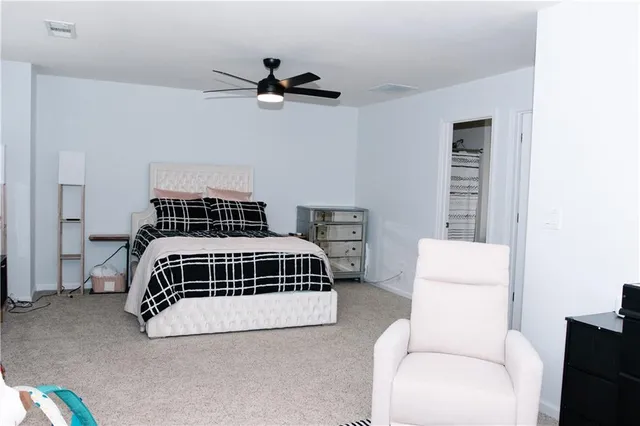a bedroom with a bed and a ceiling fan