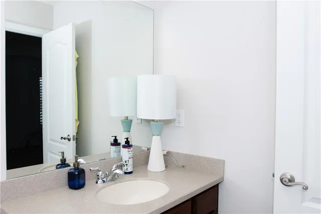 a bathroom with a sink and a mirror