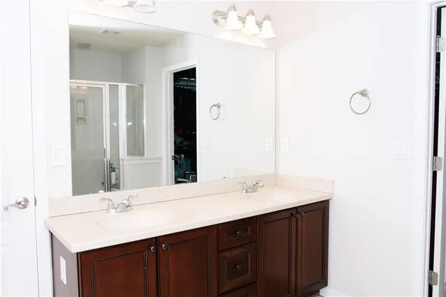 a bathroom with a double vanity sink and a mirror