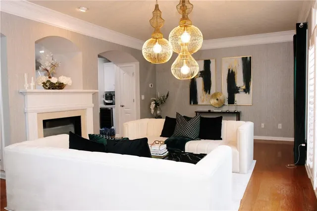 a living room with fireplace furniture and a mirror