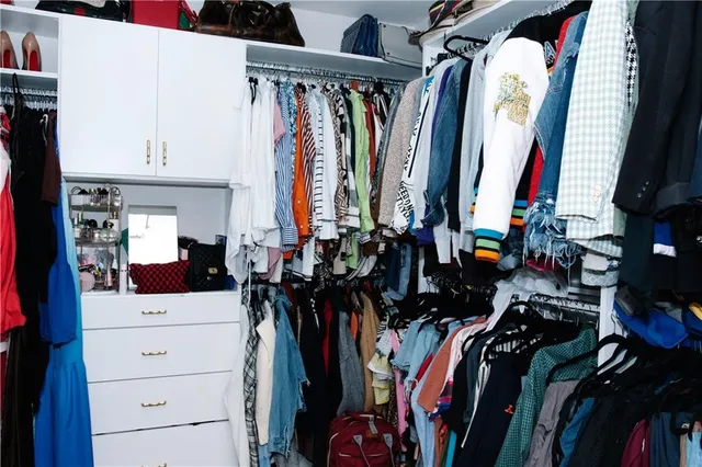 a view of walk in closet with clothes