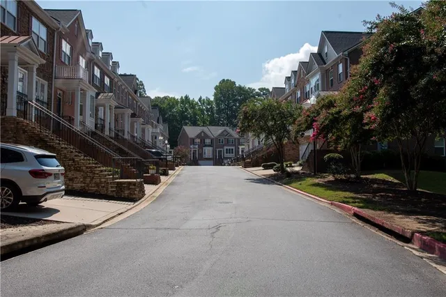 a view of a street with houses on both side