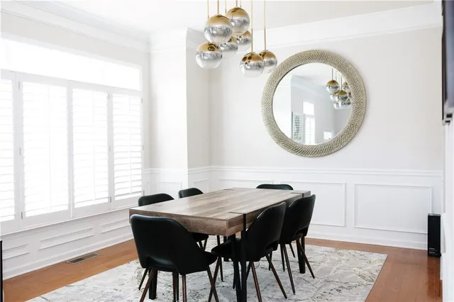 a dining room with a wooden table and chairs