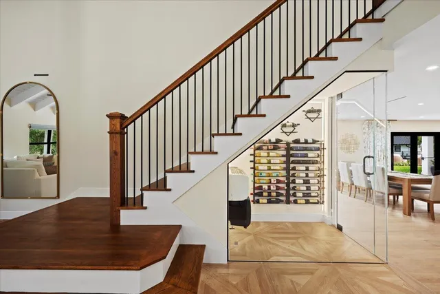 a living room with stainless steel appliances kitchen island furniture and a large window