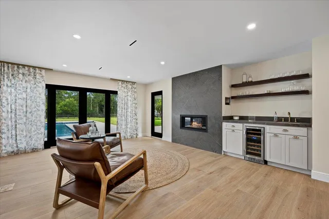 a view of a patio with a table chairs and a yard
