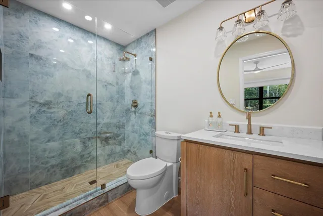 a bathroom with a sink toilet and shower