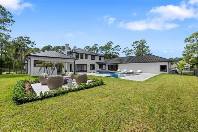 an aerial view of a house with a yard basket ball court and outdoor seating