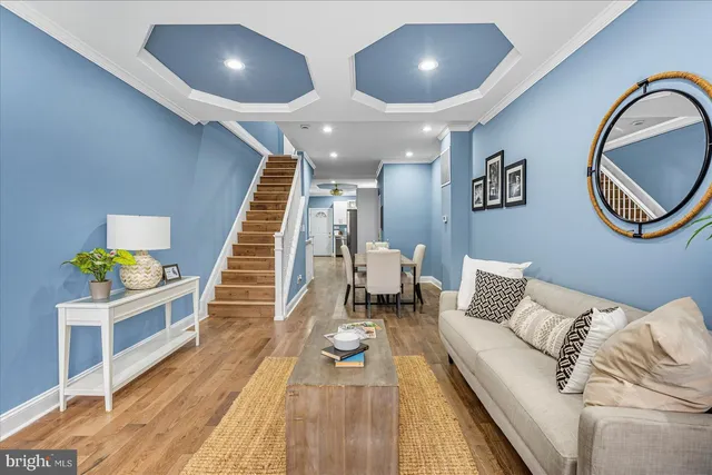a living room with furniture and wooden floor