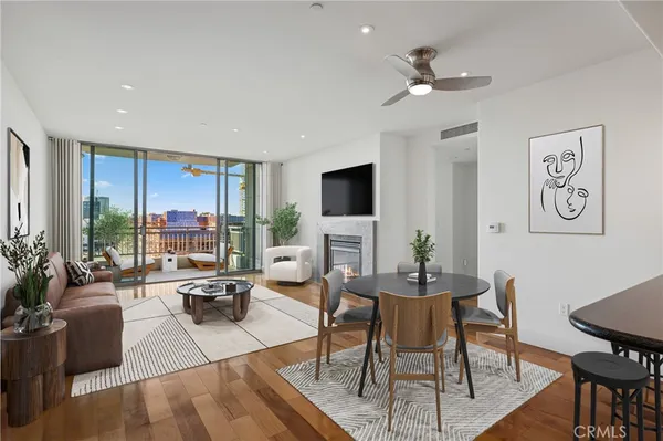 a living room with furniture a large window and a flat screen tv