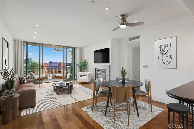 a living room with furniture a large window and a flat screen tv
