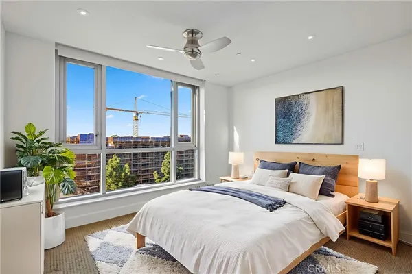 a bedroom with a large bed and a window