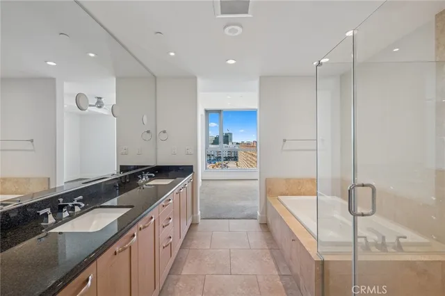 a view of an empty room with wooden floor and a ceiling fan