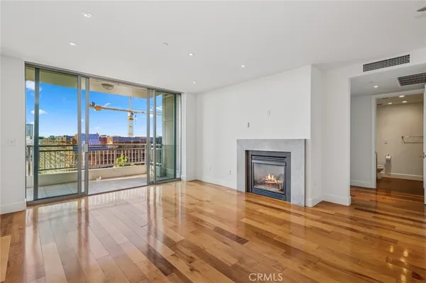 a large kitchen with stainless steel appliances a large counter top a sink and a refrigerator