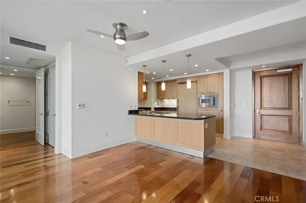 a kitchen with stainless steel appliances granite countertop a sink and a refrigerator