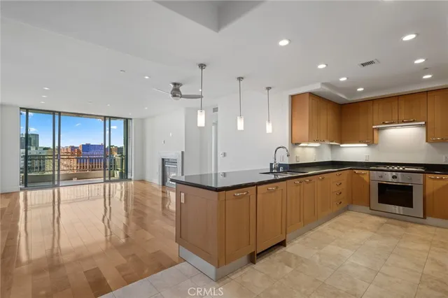 a view of empty room with wooden floor and fireplace