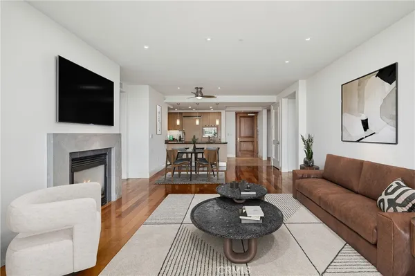 a living room with furniture a flat screen tv and a fireplace