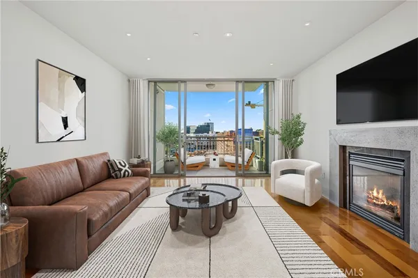 a living room with furniture fireplace and flat screen tv