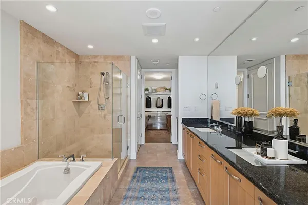 a large bathroom with a double vanity sink a large mirror and shower