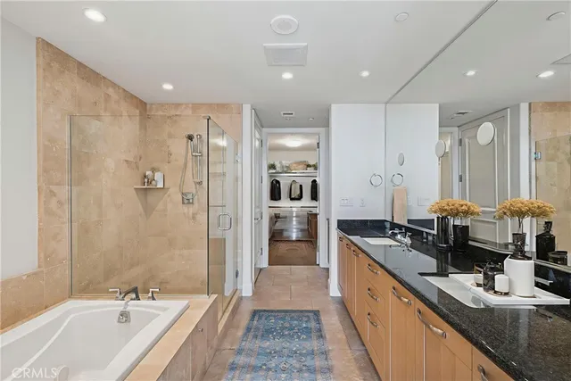 a large bathroom with a double vanity sink a large mirror and shower
