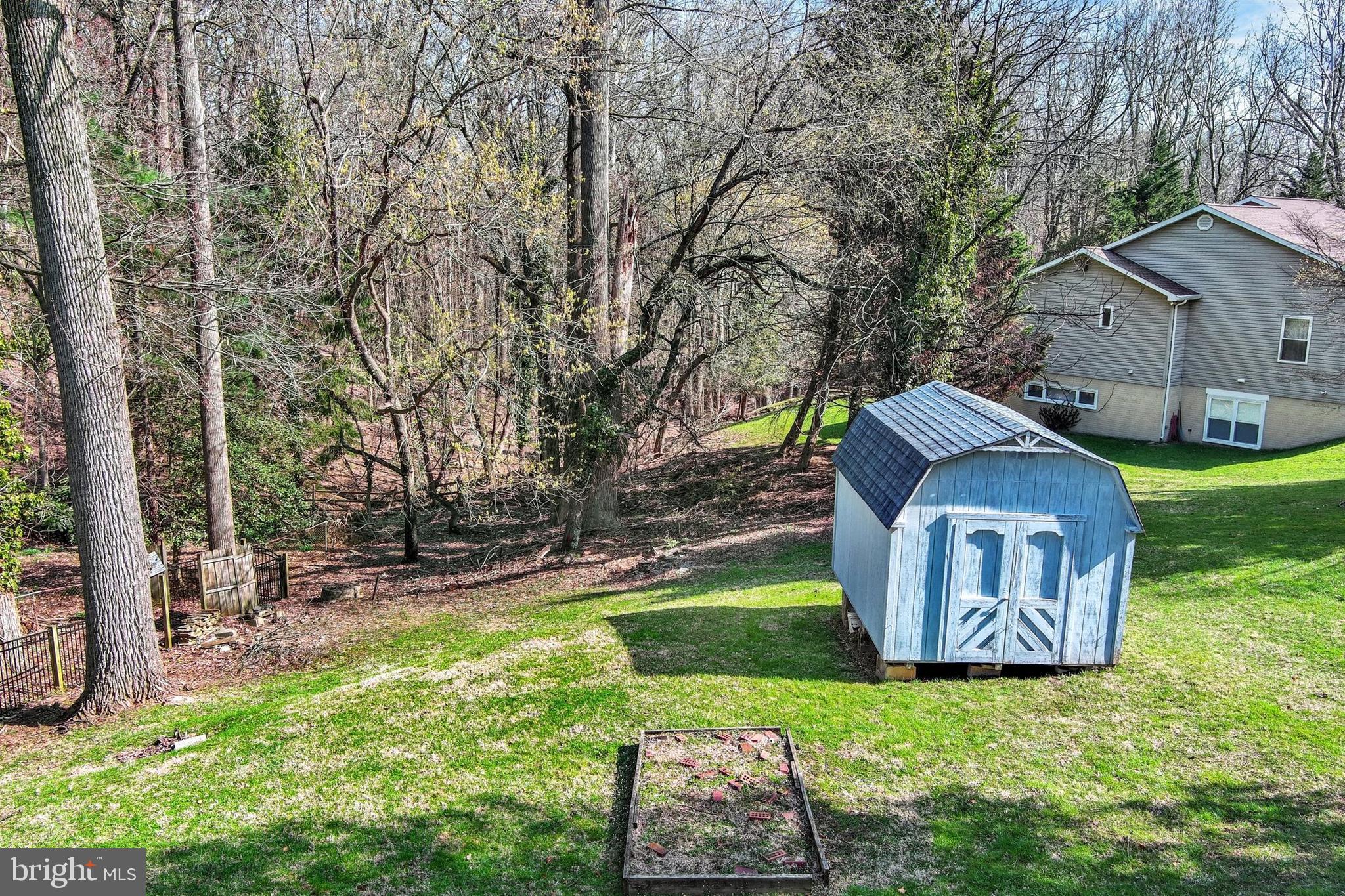 2926 Knoll Acres Drive Baltimore, MD 21234 - Photo 45 of 49 a backyard of a house with table and chairs