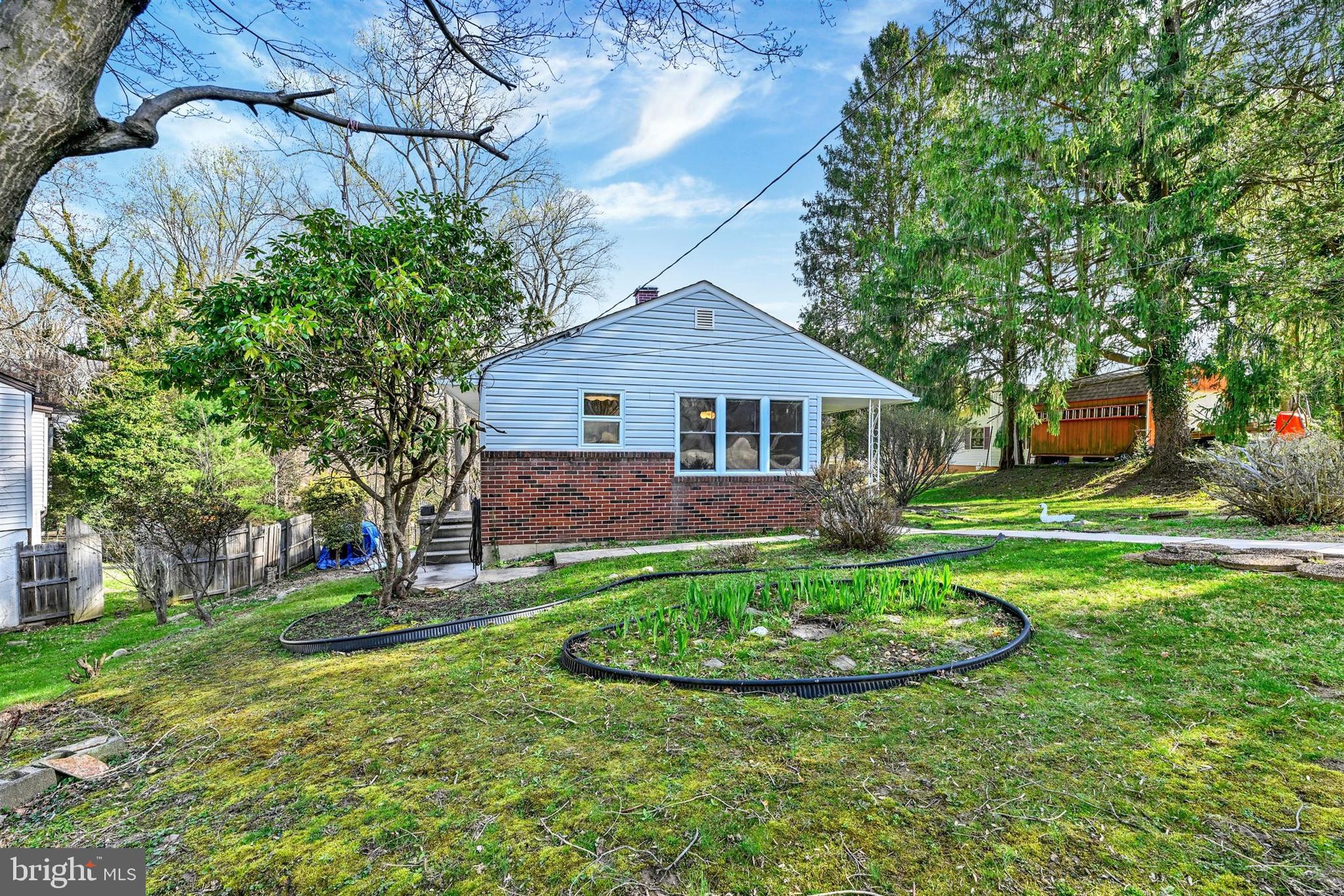 2926 Knoll Acres Drive Baltimore, MD 21234 - Photo 47 of 49 a view of a house with a big yard potted plants and large tree