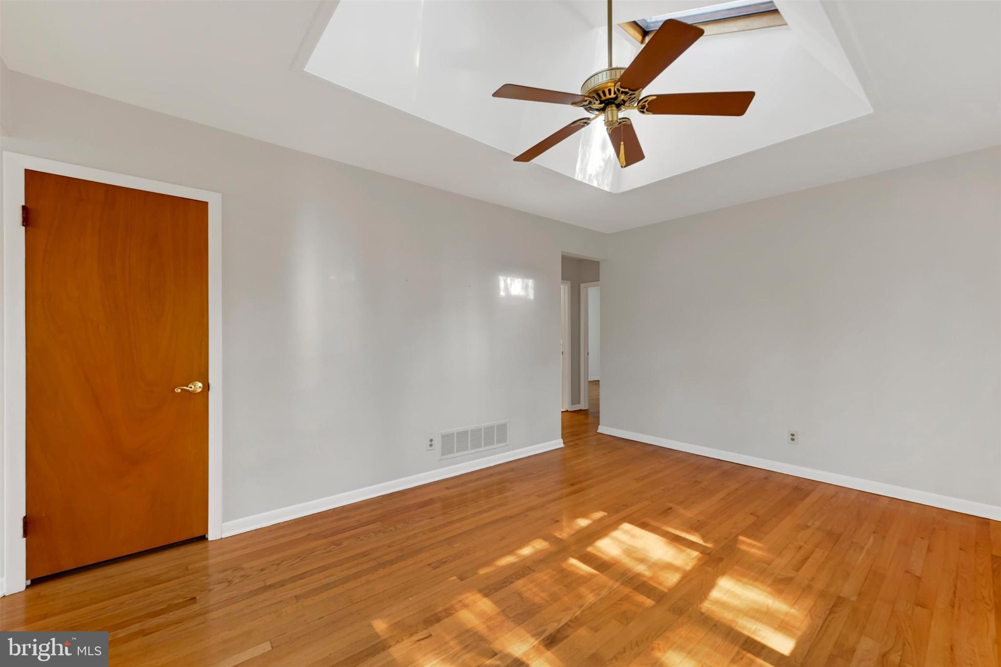 2926 Knoll Acres Drive Baltimore, MD 21234 - Photo 6 of 49 a view of room with wooden floor and ceiling fan