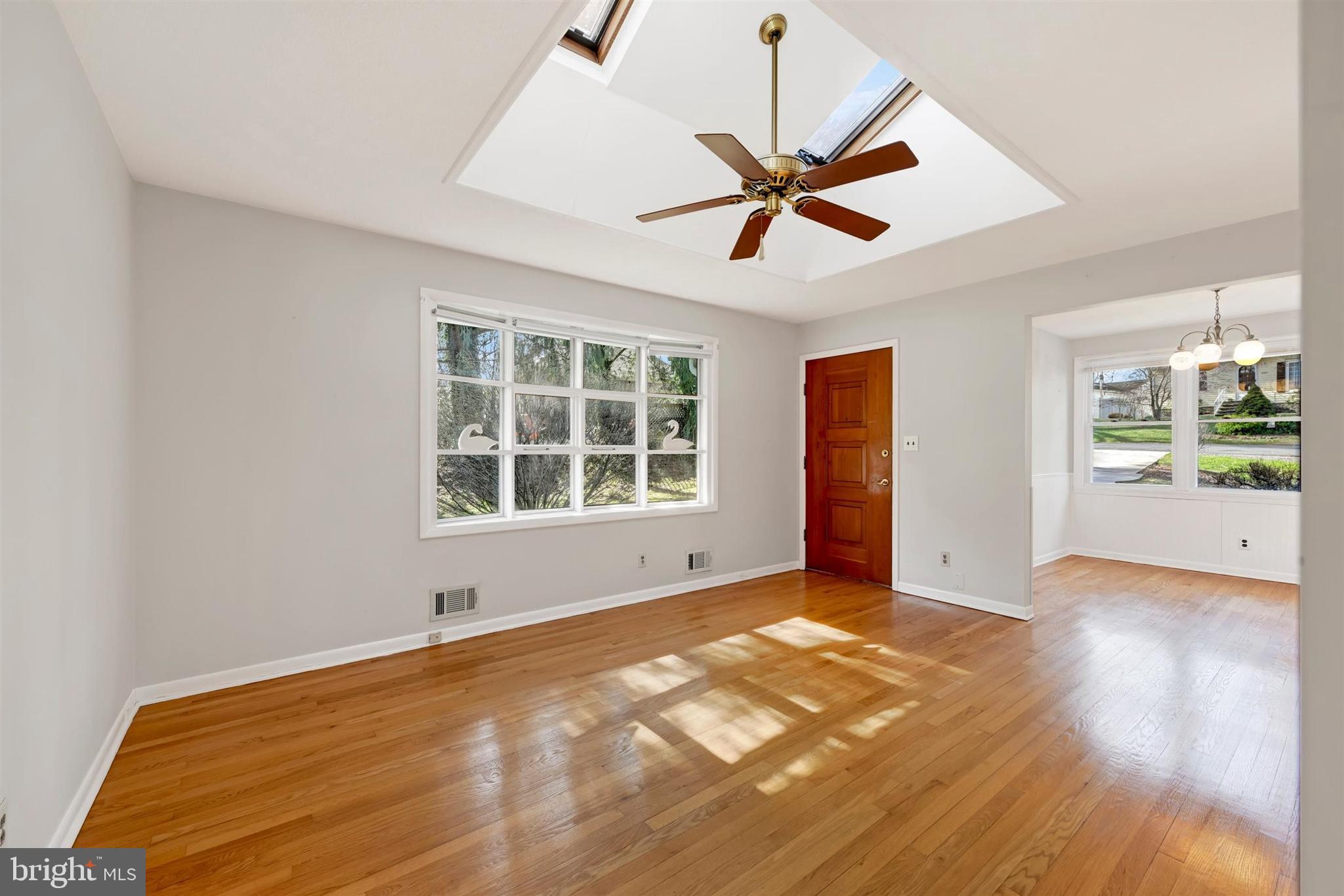 2926 Knoll Acres Drive Baltimore, MD 21234 - Photo 7 of 49 a view of an empty room with wooden floor and a window