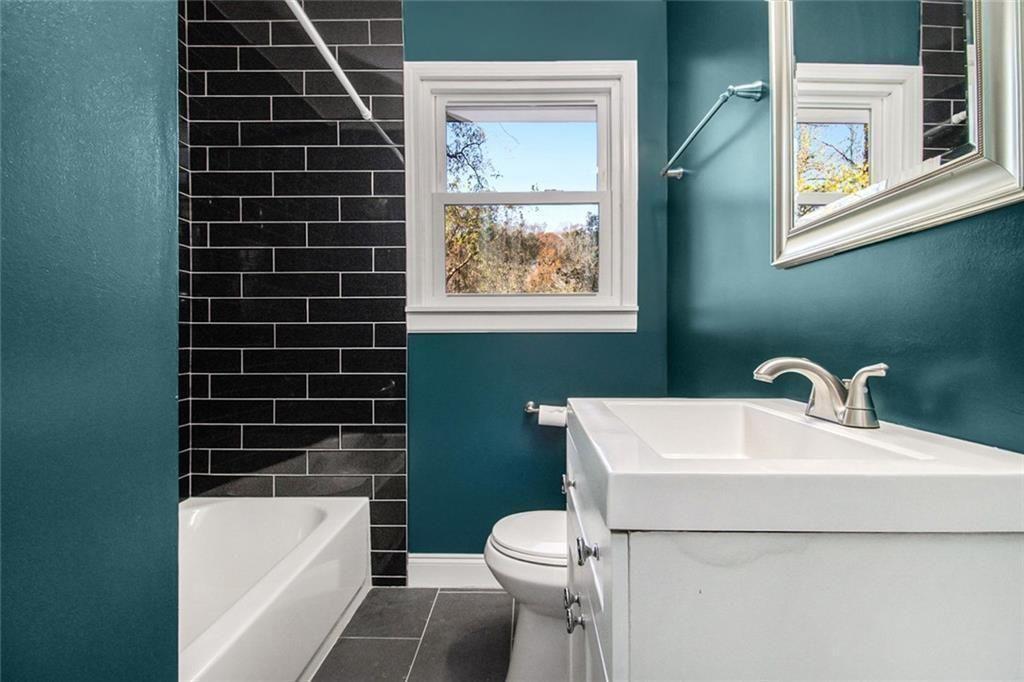 1723 Capistrana Place Decatur, GA 30032 - Photo 14 of 28 a bathroom with a sink toilet and shower