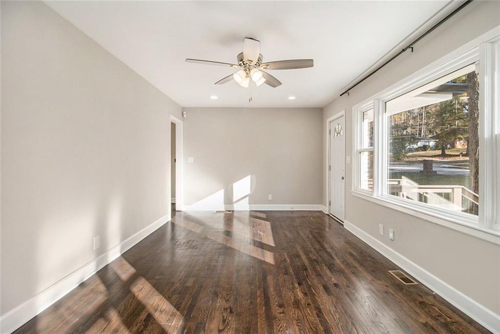 1723 Capistrana Place Decatur, GA 30032 - Photo 8 of 28 a view of an empty room with wooden floor and a window