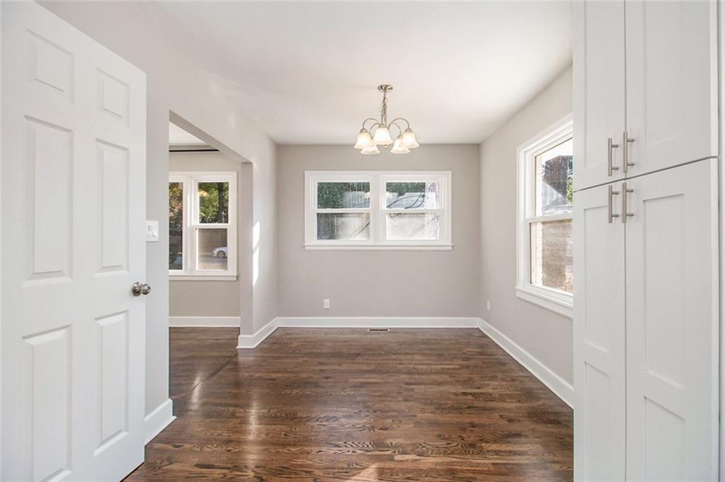 1723 Capistrana Place Decatur, GA 30032 - Photo 9 of 28 an empty room with wooden floor and windows