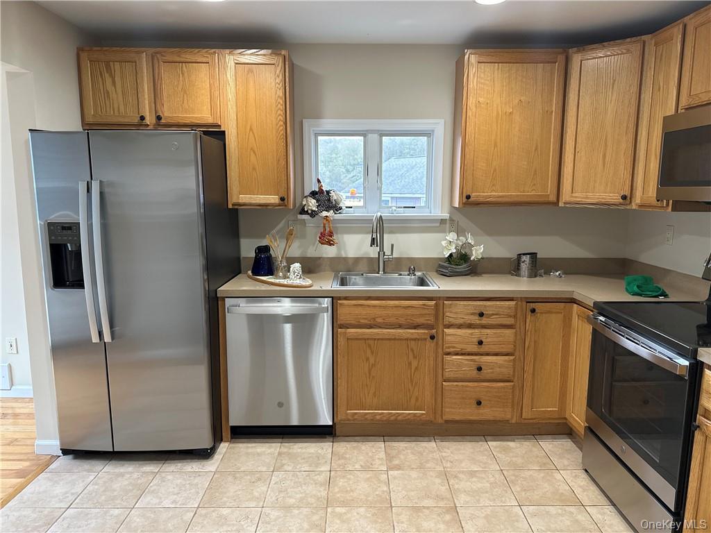 100 Dunderberg Road Putnam Valley, NY 10579 - Photo 2 of 29 a kitchen with stainless steel appliances a stove sink and refrigerator