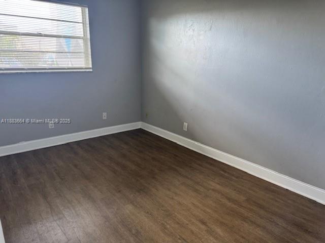 Coral Ridge Isles Fort Lauderdale, FL 33334 - Photo 12 of 17 an empty room with wooden floor and windows