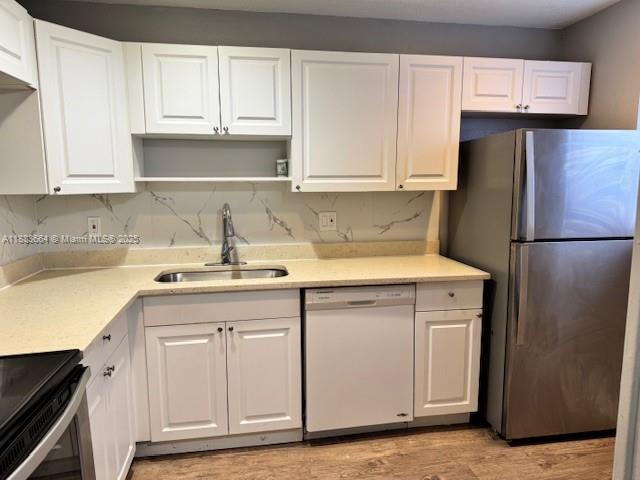Coral Ridge Isles Fort Lauderdale, FL 33334 - Photo 15 of 17 a kitchen with a sink and a refrigerator